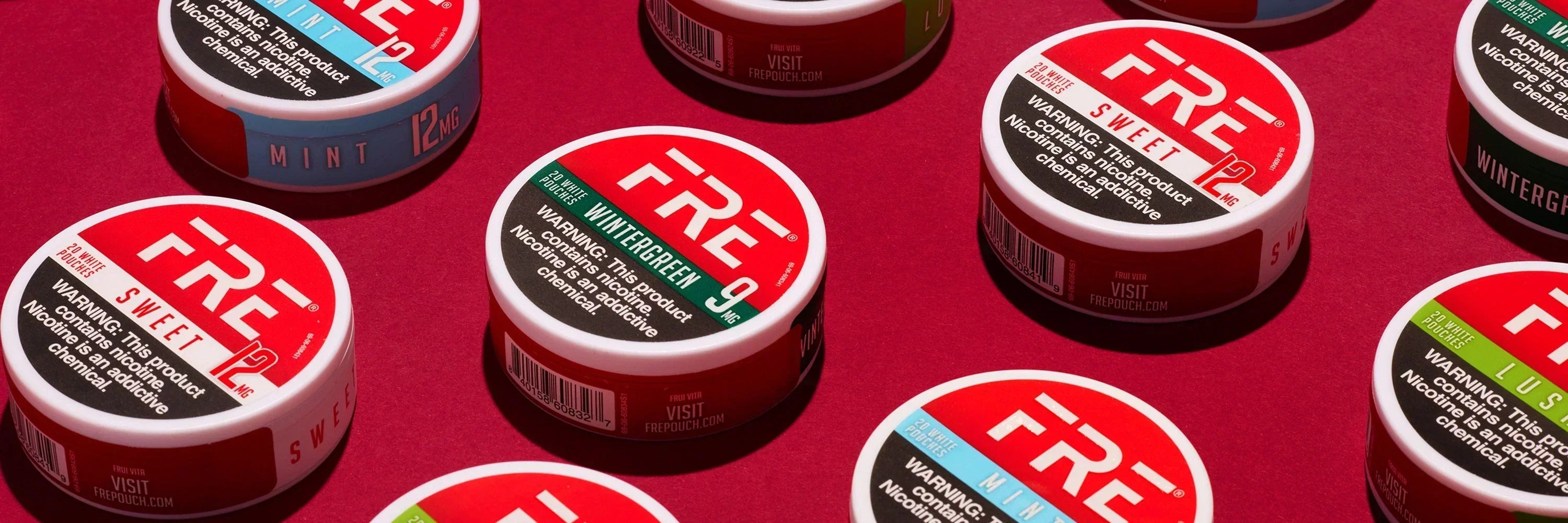 FRE nicotine pouches in mint, wintergreen, sweet, and lush flavors on red background