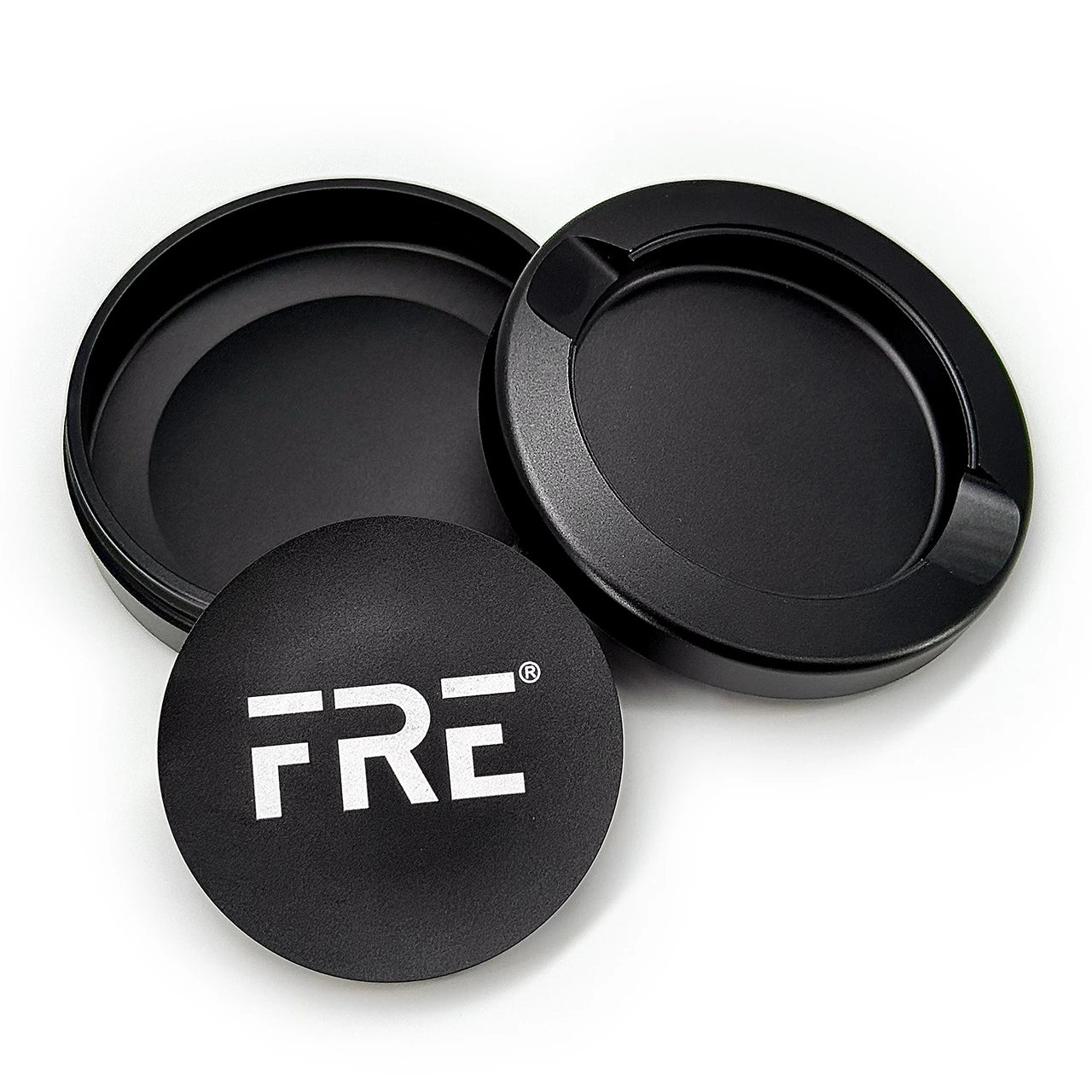 premium metal tin in black with removable top, discreet discard compartment, and bold white FRE logo on matte-finish lid
