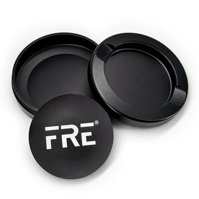premium metal tin in black with removable top, discreet discard compartment, and bold white FRE logo on matte-finish lid