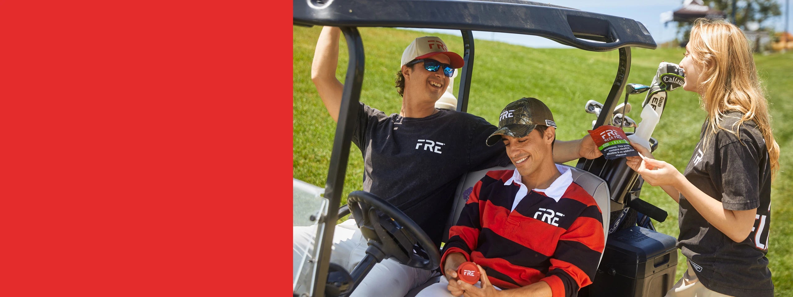 Three people in a golf cart with FRE logo apparel on a grassy field