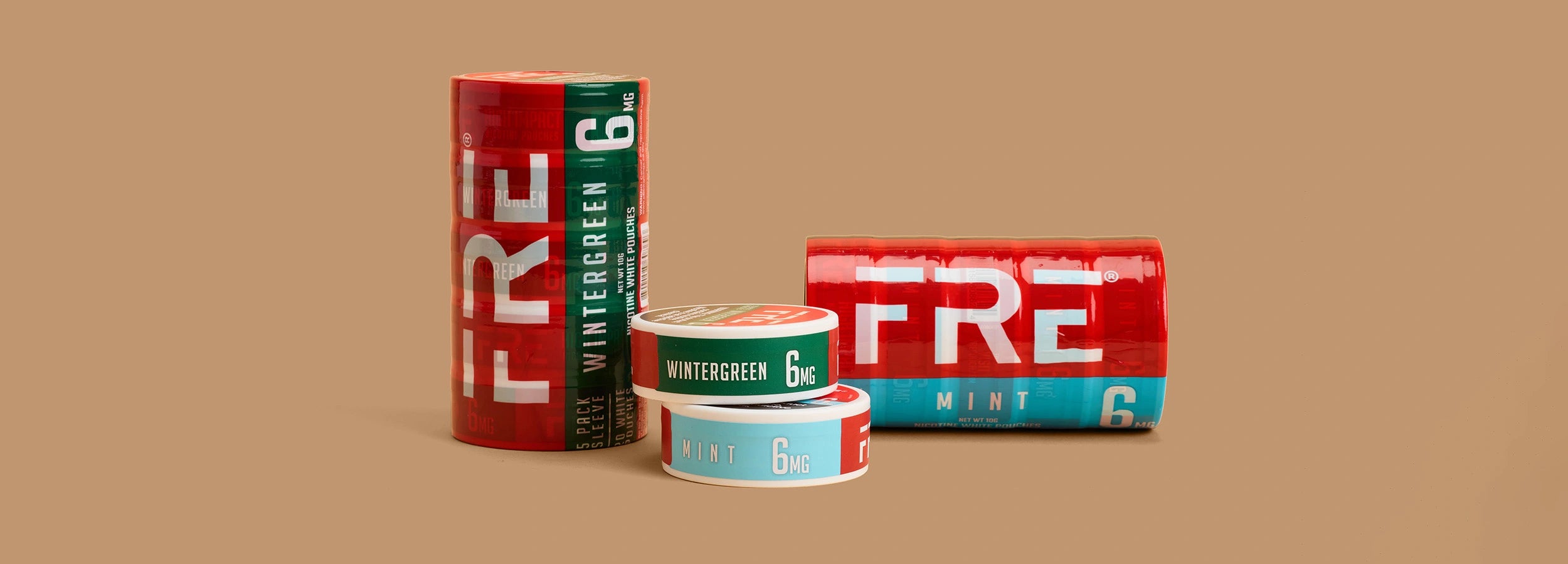 FRE Pouch nicotine tins and multipack rolls in Wintergreen and Mint flavors, showing bold red and green packaging with 6mg strength