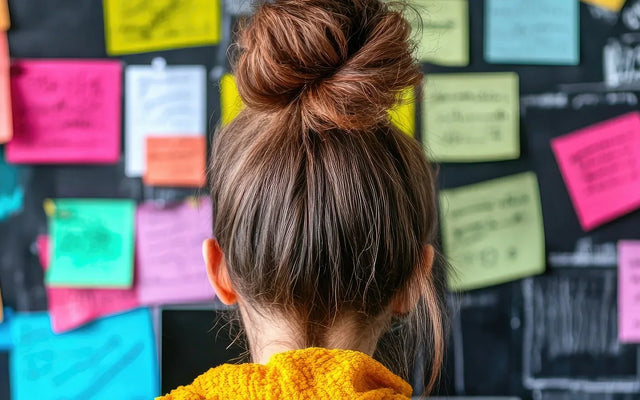 woman in office with post it notes on the wall