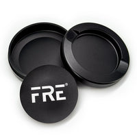 premium metal tin in black with removable top, discreet discard compartment, and bold white FRE logo on matte-finish lid
