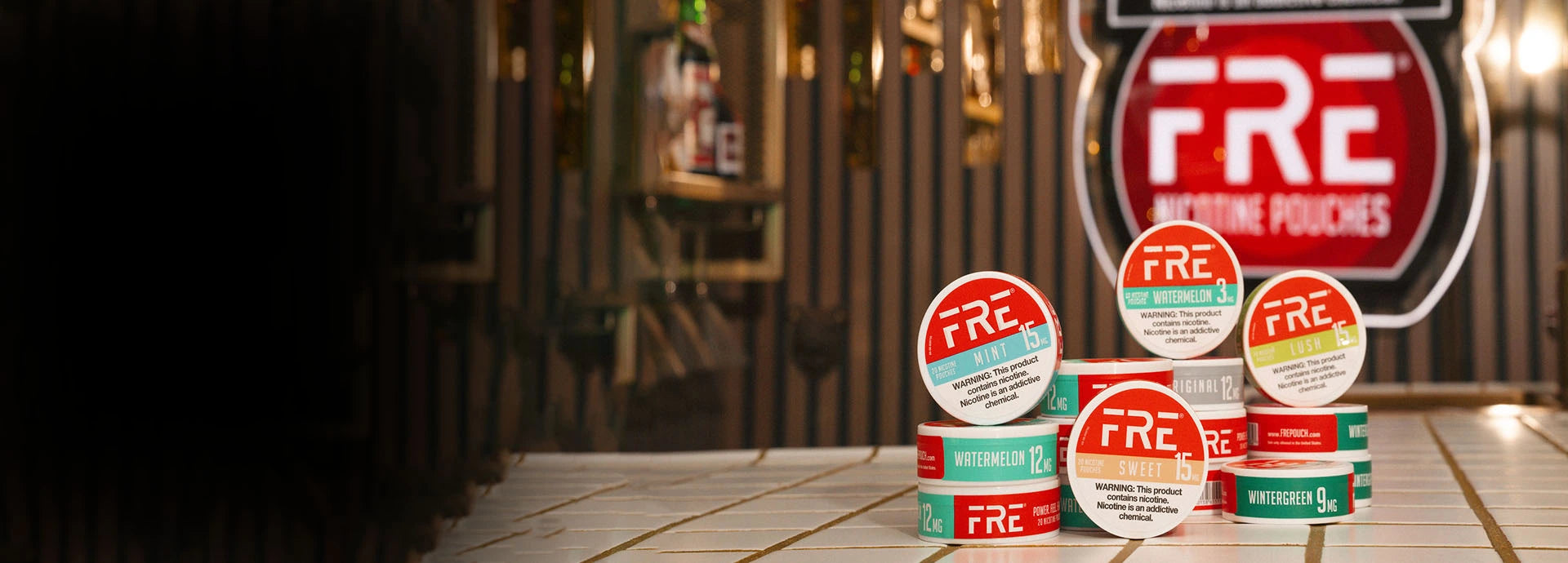 Stack of FRE zero-tobacco pouches on a bar counter with a blurred bar background